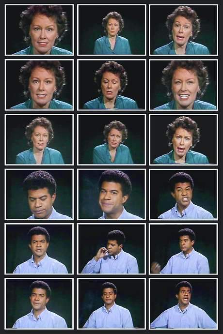 Two head‑height monitors on pedestals each display a close‑up portrait: a young Black man on the left and an older White woman on the right. Both recite hundred phrases five times, starting in a flat neutral tone and becoming increasingly animated and angry by the final iteration. Their differing deliveries cause a time slippage, so when looped the tapes fall out of sync.